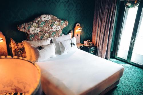 a bedroom with a large bed with a large headboard at Pensão Amor Madam's Lodge in Lisbon