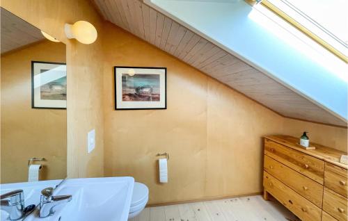 a bathroom with a sink and an attic at Lovely Apartment In Fvang With Wifi in Favang