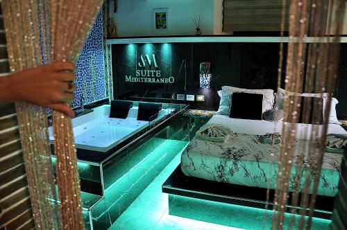 a room with a bed and a tub in it at Suite Mediterraneo in Civitavecchia