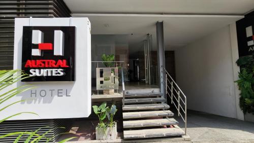 a building with a staircase leading to a hotel at Hotel Austral Suites in Cali