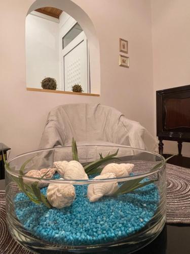 a glass bowl with two stuffed animals in it at Emerald Apartment in Spata
