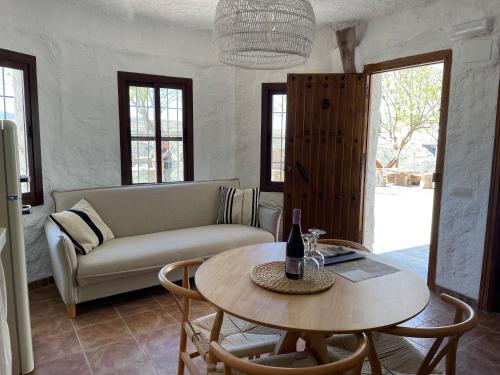 a living room with a table and a couch at Cuevas El Atochal Orígenes in Gor