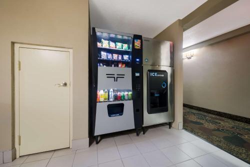 a refrigerator in a room with a drink dispenser at Best Western Executive Inn in Battle Creek