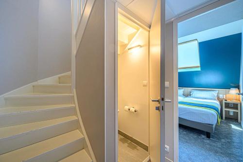 a room with a staircase leading to a bedroom at Best Western Plus Hôtel Vannes Centre Ville in Vannes