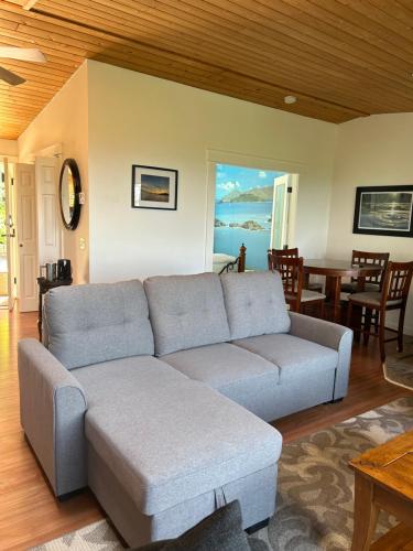 a living room with a couch and a table at Armand Heights in Ganges