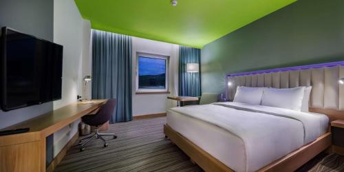 a bedroom with a bed and a desk and a tv at Park Inn by Radisson Samsun in Samsun