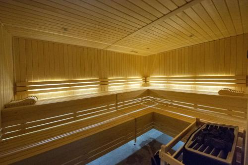 an empty pool in a sauna with a bench in it at Best Western Premier Le Chapitre Hotel and Spa in Remiremont