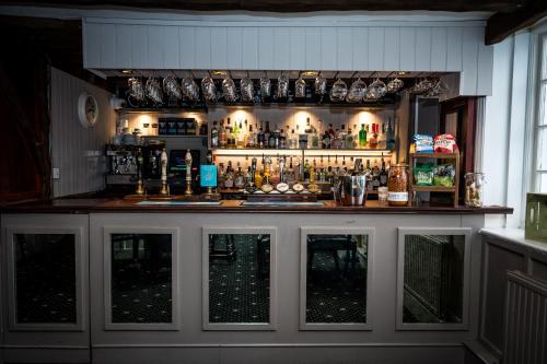 a bar with a lot of bottles and glasses at Findon Manor Hotel in Worthing
