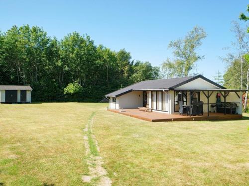 a small house with a large yard in front of it at 5 person holiday home in Føllenslev-By Traum in Føllenslev