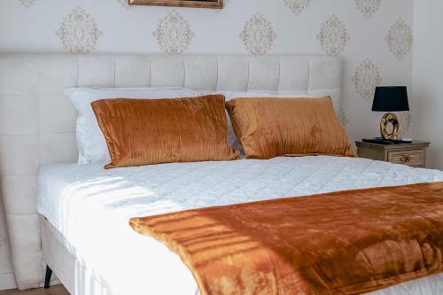 - un lit blanc avec 2 oreillers orange dans l'établissement Belgrade Waterfront 1409, à Belgrade