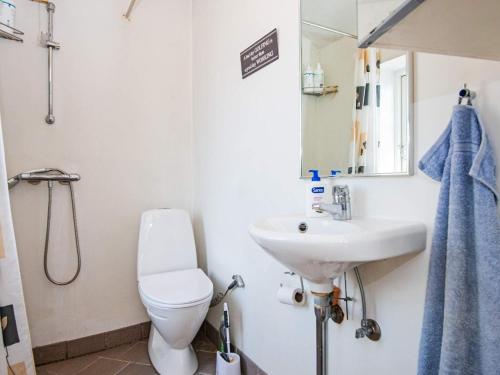 a bathroom with a toilet and a sink and a mirror at 4 person holiday home in Malling-By Traum in Malling