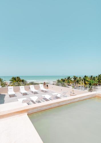a view of the beach from the pool at the resort at Dos Mares Barefoot Luxury in El Cuyo