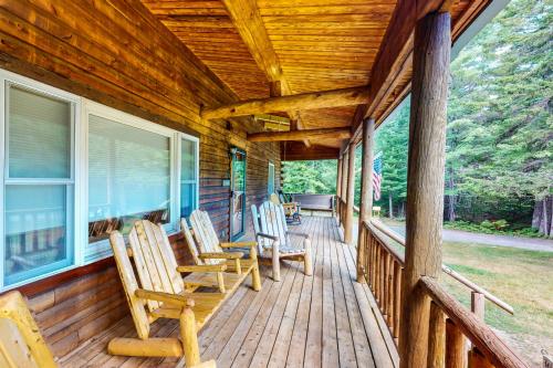 a porch of a cabin with rocking chairs on it at Silver's Log Cabin in Trenton