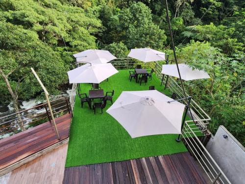 an overhead view of a patio with tables and umbrellas at Eco Hotel Villa Suites in Quillabamba