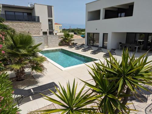 a swimming pool in the middle of a house at Villa SunSet in Privlaka