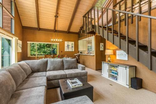 a living room with a couch and a table at Lazy River Lodge - Hot Tub On the River Kayaks in Guerneville