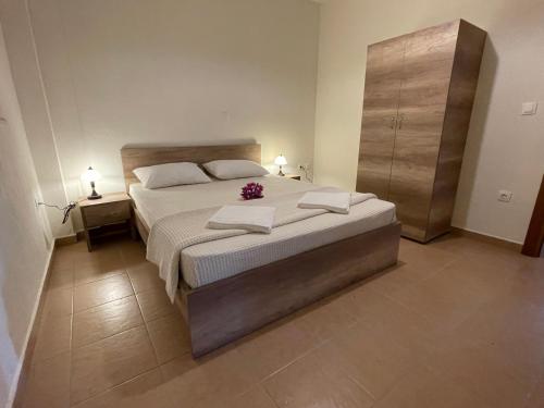 a bedroom with a large bed and two night stands at Ammouliani Apartments in Ammouliani