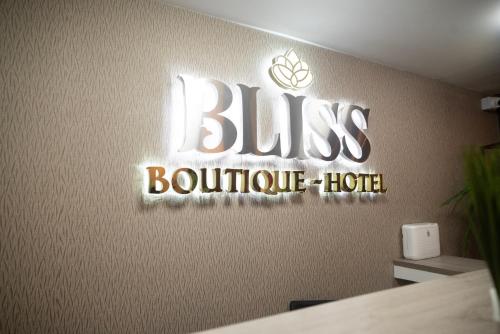 a sign for a bus boutique hotel on a wall at BLISS BOUTIQUE HOTEL BOGOTA in Bogotá