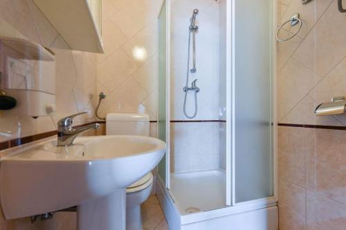 een badkamer met een wastafel, een douche en een toilet bij Apartments by the sea Lukovo Sugarje, Karlobag - 21469 in Karlobag
