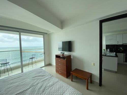 a bedroom with a bed and a view of the ocean at Apartamentos Palmetto Eliptic ICDI in Cartagena de Indias