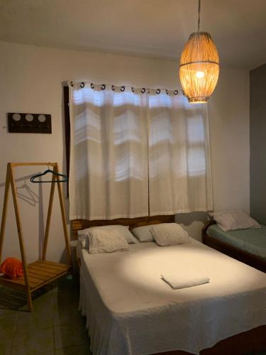 a bedroom with a bed and a window and a lamp at Bed & Breakfast Casa de Valeria in Barra Nova