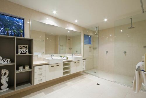 a large bathroom with two sinks and a shower at 20 Wesley Court, Noosa Heads in Noosa Heads