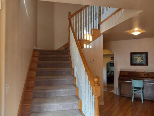 a staircase in a home with a stair case at Red Creek Inn and Farm in Paragonah