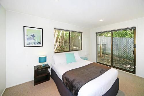 a bedroom with a bed and a large window at 21 Arakoon Crescent, Sunshine Beach in Noosa Heads