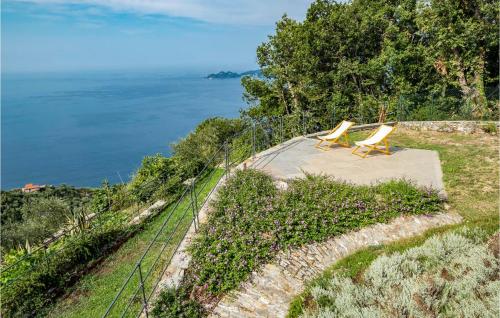 two yellow chairs sitting on a hill next to the ocean at S Rocco Dimora Tra Ulivi E M in Zoagli