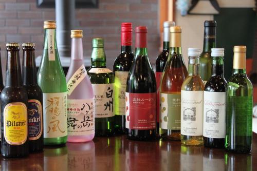 a group of wine bottles sitting on a table at Pension Field in Hokuto
