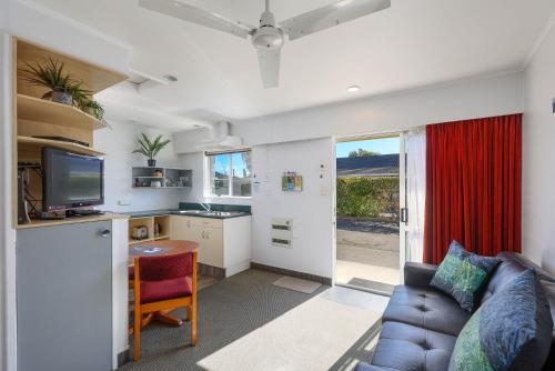 a living room with a couch and a table at ASURE Fountain Resort Motel in Nelson