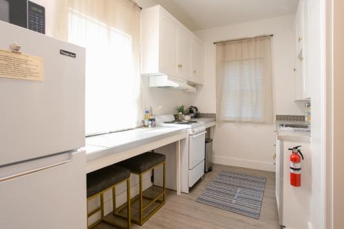 a kitchen with white cabinets and a counter top at Oakdale Suites - Master Property in Medford