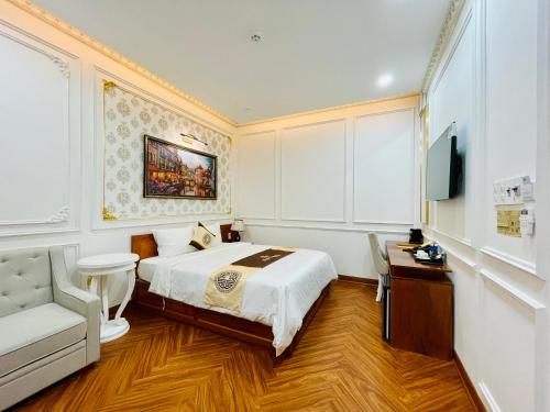 a hotel room with a bed and a tv at NEW PALACE HOTEL in Quang Ngai