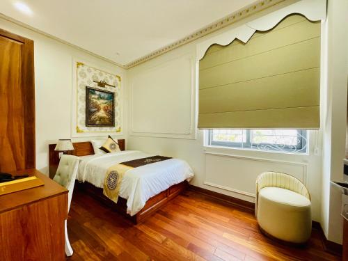 a bedroom with a bed and a window at NEW PALACE HOTEL in Quang Ngai