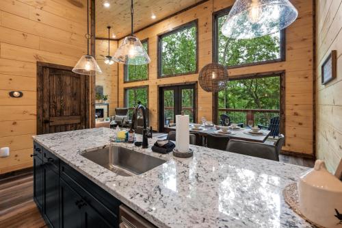 a kitchen with a sink and a counter top at New Cozy Mountain Cabin Hot Tub Near Downtown in Gatlinburg