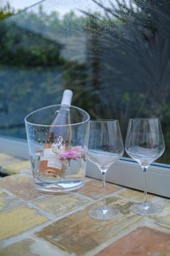 three wine glasses sitting on a table with a window at Il Giardino Di Epicuro in Rocca San Giovanni