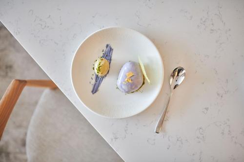 a plate of food on a table with a spoon at The Westin London City in London