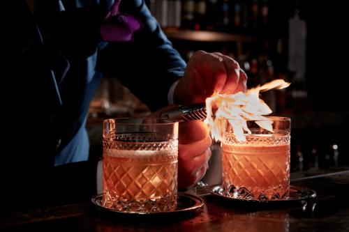 a bartender prepares two cocktails on a bar at The St. Regis Osaka in Osaka