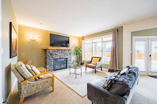 a living room with two couches and a fireplace at Kelowna Spacious 3 Bedroom House in Kelowna