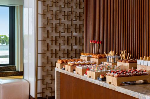 a bakery with a display of pastries on a counter at Baku Marriott Hotel Boulevard in Baku