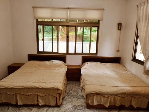 Postel nebo postele na pokoji v ubytování Half Sky Lin Yuan Homestay
