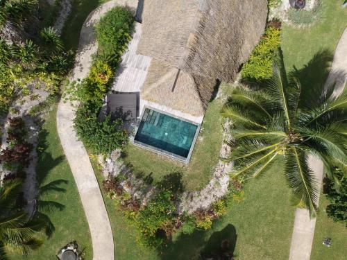 an aerial view of a house with a swimming pool at Maitai Lapita Village Huahine in Fare