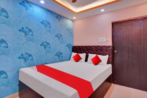 a bedroom with a bed with a blue wall at Flagship Hotel Relax Rainbow in Gulzārbāgh