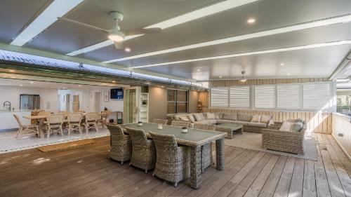 a living room with a ping pong table and chairs at Coral Paradise - Metres From Beachfront in Pearl Beach