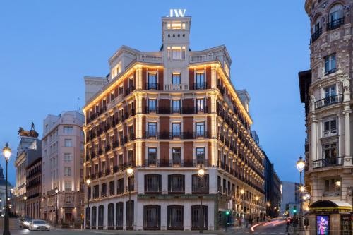 a lit up building on a city street at night at JW Marriott Hotel Madrid in Madrid
