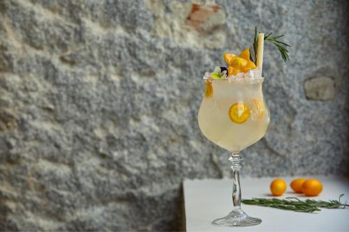 a drink with oranges in a glass on a table at JW Marriott Hotel Madrid in Madrid
