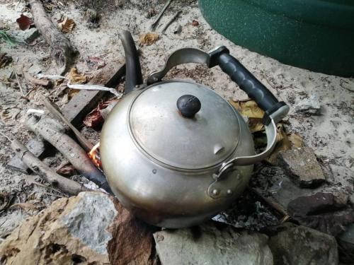 a tea pot sitting on top of a stove at Koh Phaluai beach cottage in Koh Phaluai
