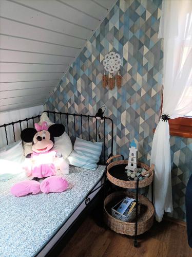 a bedroom with a bed with a stuffed animal on it at Vendégház a Csabay Kúriához in Lakitelek