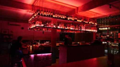 a bar with people sitting at a bar at D’Leroi Soleil - Westlake Suite & Apartment in Hanoi