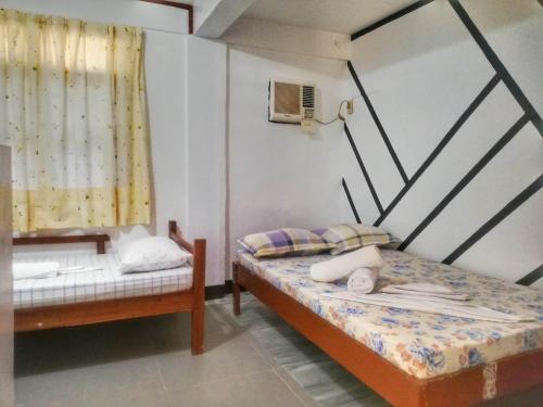 Ένα ή περισσότερα κρεβάτια σε δωμάτιο στο Blessed Inn Annex